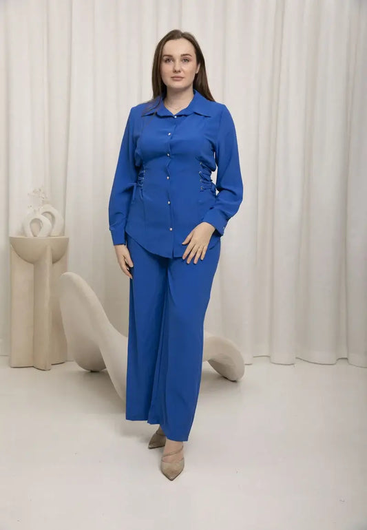 2-piece blue linen set featuring a cuffed sleeve button-down blouse with matching trousers.