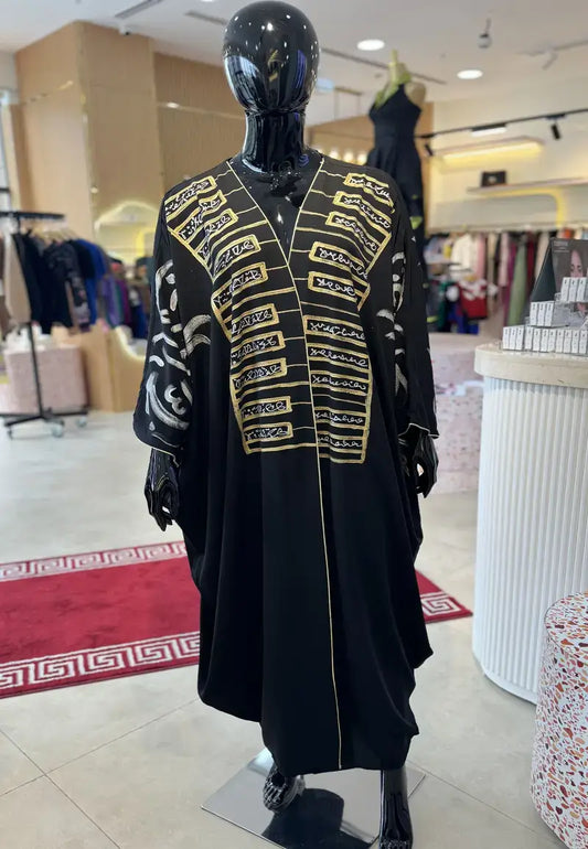 Luxurious black and white abaya embroidered with golden letters